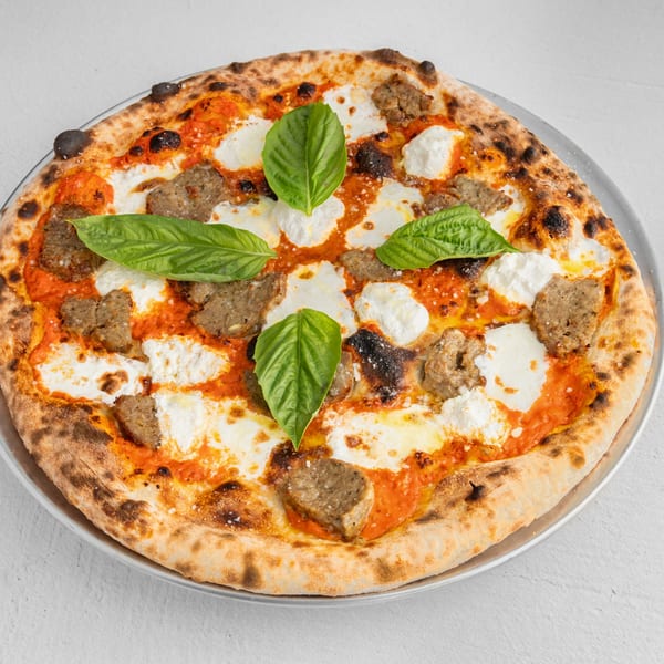 How Ya Dough'n Pizza's sausage pizza with dollops of ricotta cheese and fresh basil leaves.