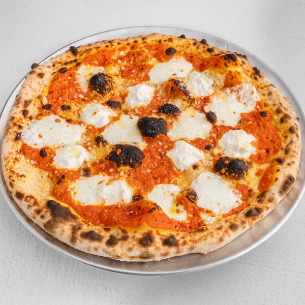 How Ya Dough'n Pizza's Margherita pizza with fresh mozzarella, tomato sauce, and basil on a metal tray.