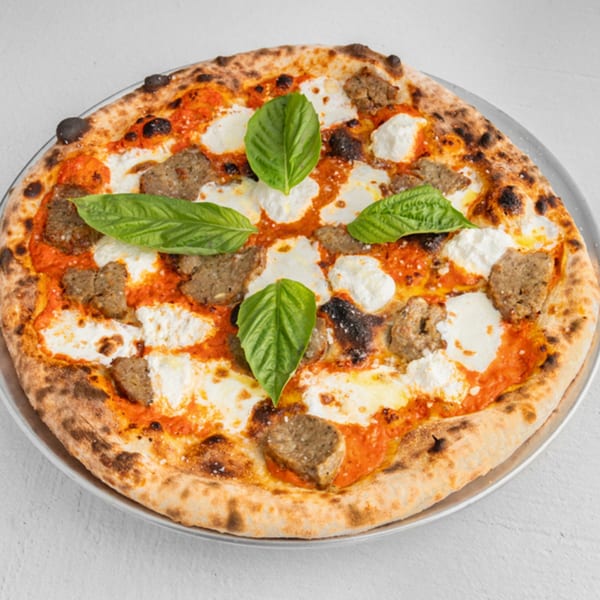 How Ya Dough'n Pizza's sausage pizza with dollops of ricotta cheese and fresh basil leaves.