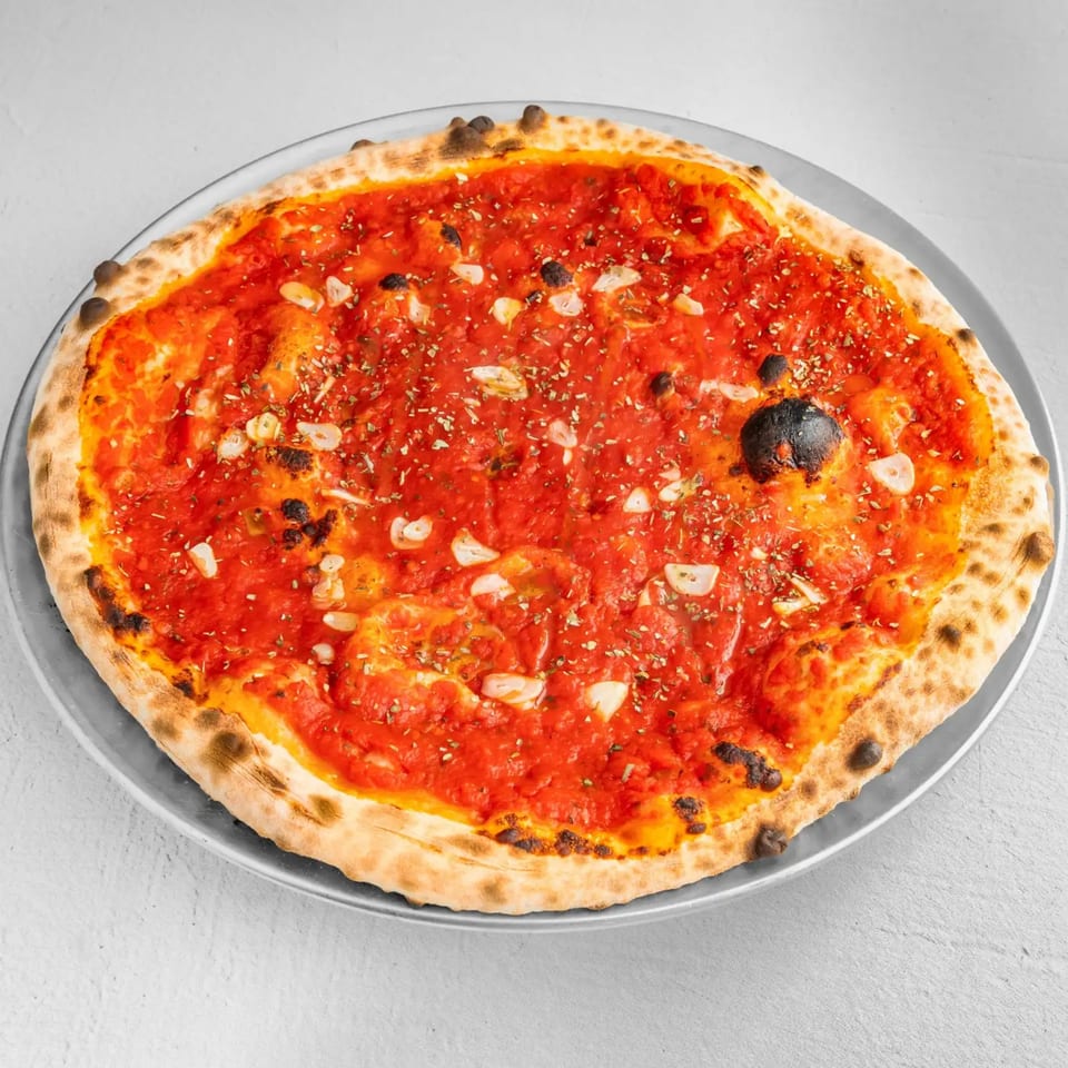 How Ya Dough'n Pizza's marinara pizza, topped with tomato sauce, garlic, and oregano.